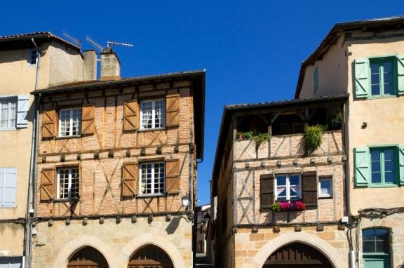 Quaint old buildings with colourful shutters in the streets and squares of Figeac