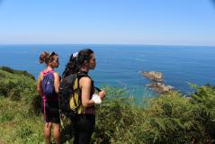 Hikers in front of the Cantabrian Sea