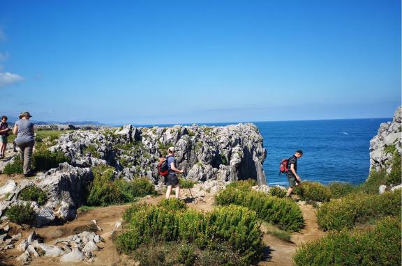 Hikers with the Cantabrian Sea in the background