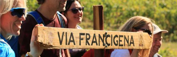 Pilgrims with a signal of Via Francigena