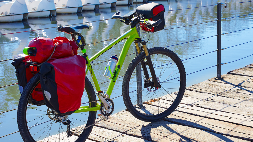 Green bike with red panniers and small front bag