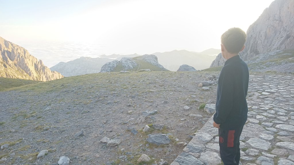 A kid staring at the landscape from the Urriellu mountain hut