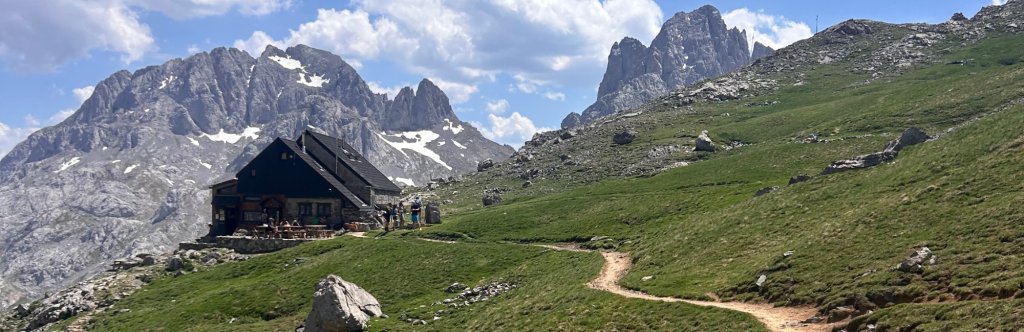 Collado Jermoso hut with Picos de Europa grey peaks behind