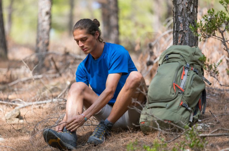 Hiker lacing up his boots
