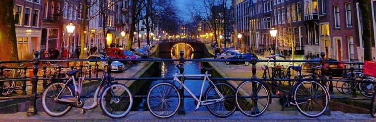 Bikes my the canal in Amsterdam at night