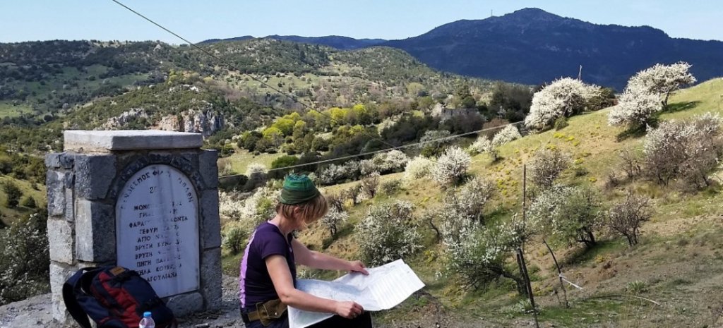 Hiker checking a map while hiking the Menalon Trail