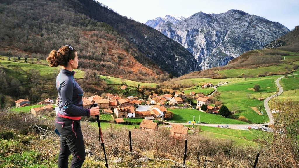 Hiker staring at village along along the camino Lebaniego